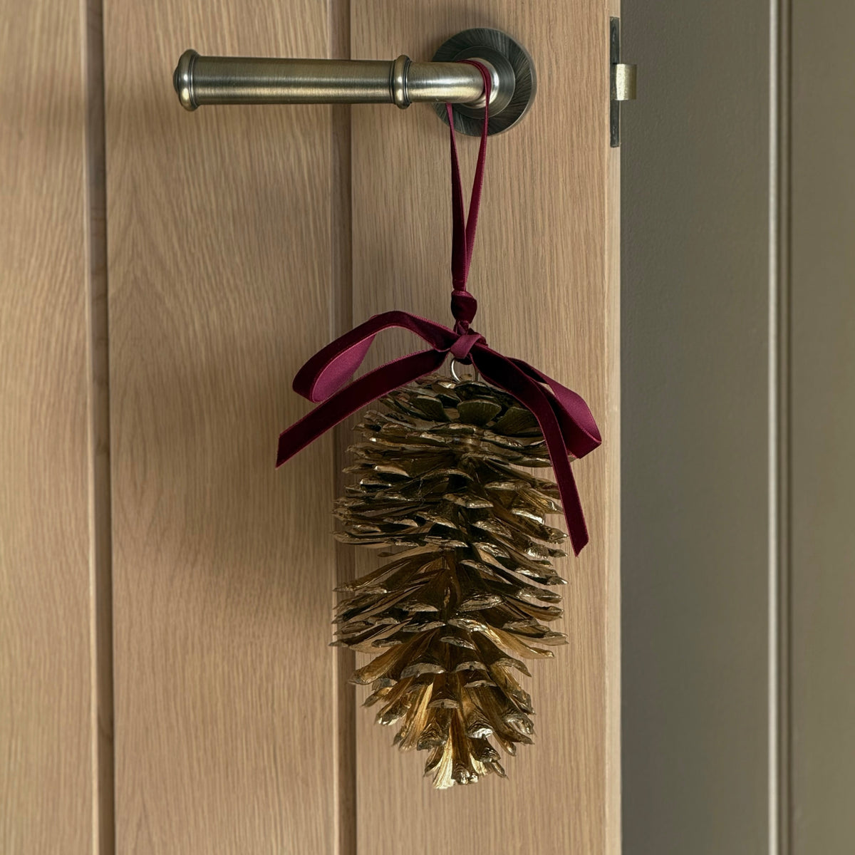 Hanging Gold Pinecone With Red Ribbon